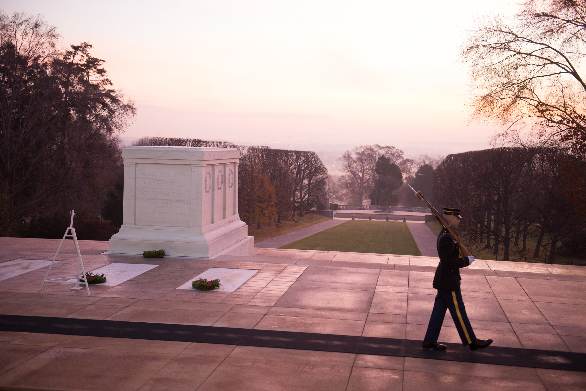 A sentinel of the U.S. Army Old Guard patrols the Tomb of the Unknown Soldier at dawn