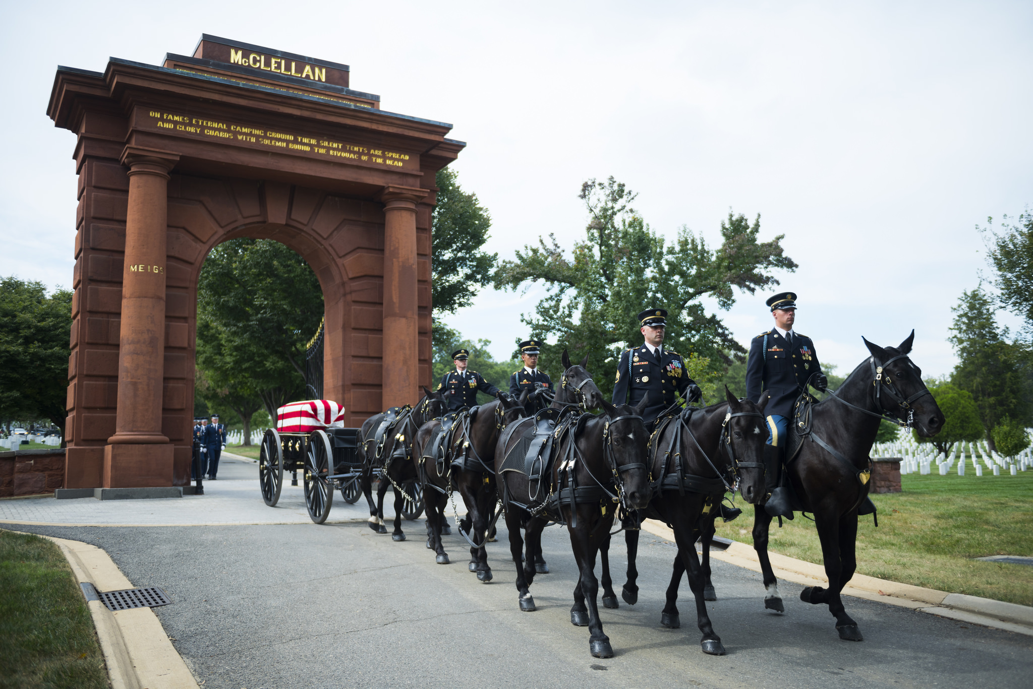 A horse-drawn caisson in a military funeral honors procession