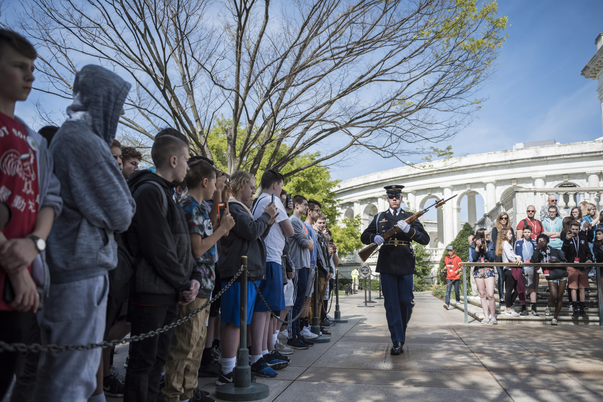 Visitors watch the changing of the guard at the Tomb of the Unknown Soldier