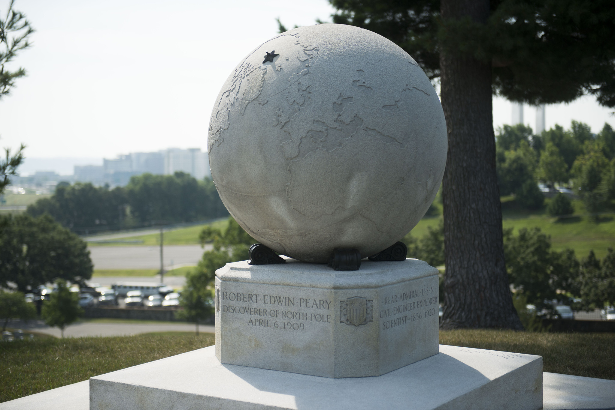 A large white marble globe, with a bronze star marking the North Pole, stands at the gravesite of famed Arctic explorer Robert Peary