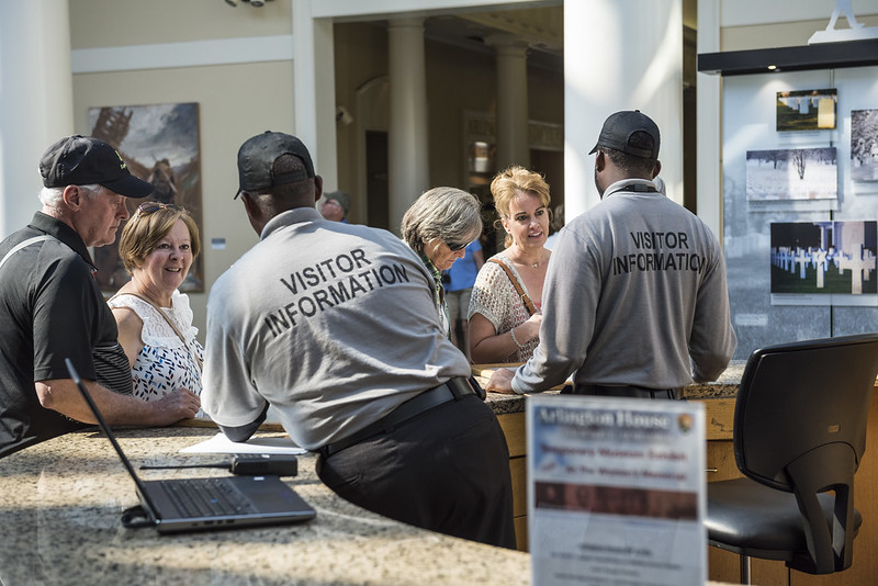 Visitor Information desk staff assist visitors