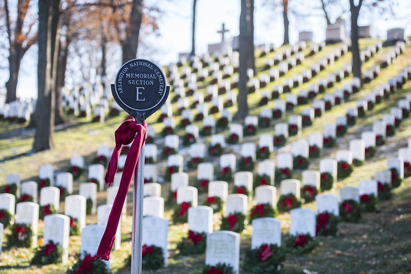 Holiday wreaths on gravestones in Arlington National Cemetery's memorial section