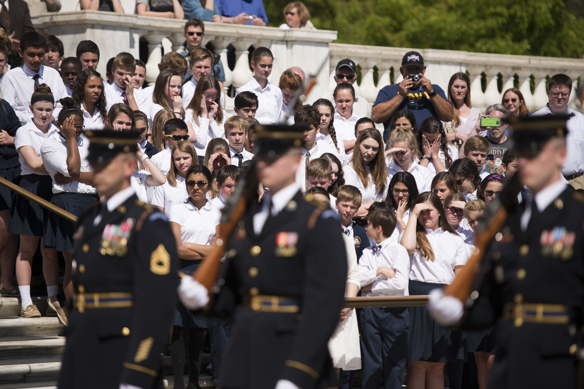A group of schoolchildren watch the changing of the guard ceremony at the Tomb of the Unknown Soldier